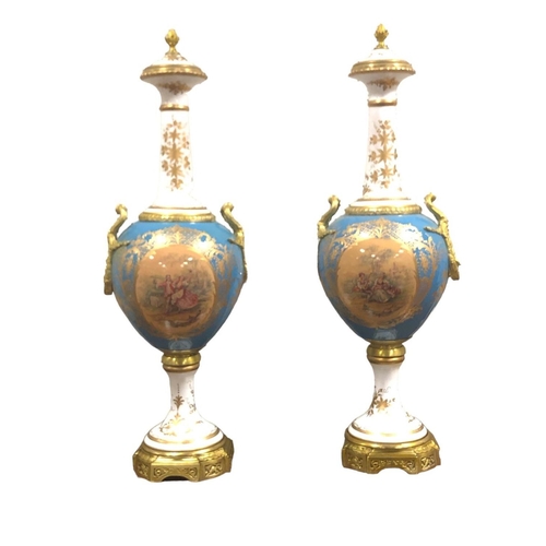 102 - A PAIR OF CONTINENTAL PORCELAIN LIDDED VASES each of bulbous form the turquoise and gilt ground with... 