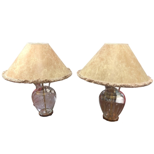 103 - A PAIR OF CLEAR GLASS AND BRASS TABLE LAMPS each of vase form raised on a pine painted platform with... 