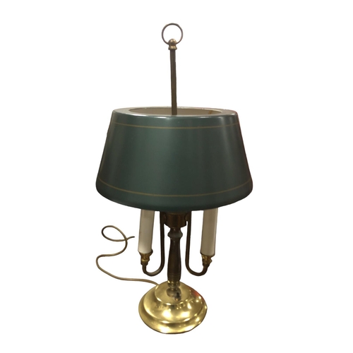 108 - A BRASS THREE BRANCH TABLE LAMP with toleware shade raised on a circular spreading foot 55cm (h)