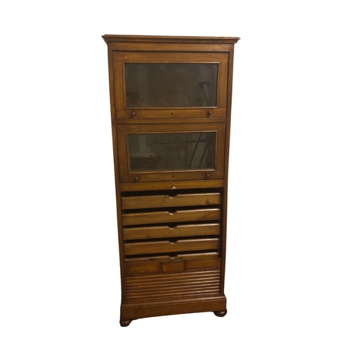 14 - A STAINED WOOD FILING CABINET of octagonal outline the shaped top with two glazed hinged doors above... 