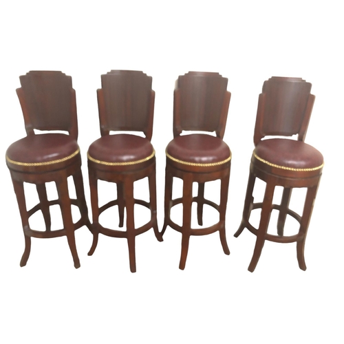 15 - A SET OF FOUR MAHOGANY AND UPHOLSTERED REVOLVING HIGH STOOLS each with a shaped back and upholstered... 