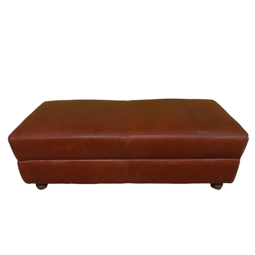 175 - A HIDE UPHOLSTERED FOOTSTOOL the rectangular upholstered seat on turned legs with castors 43cm (h) x... 