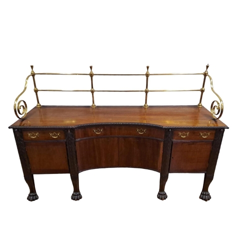 18 - AN IRISH GEORGIAN MAHOGANY SIDEBOARD of rectangular concaved outline the shaped top with brass galle... 