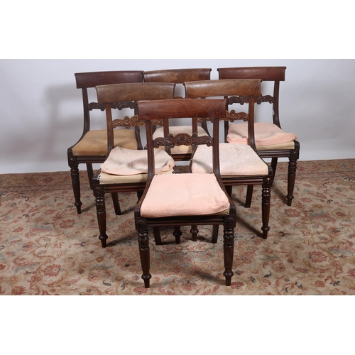 199 - A SET OF SIX REGENCY MAHOGANY DINING CHAIRS each with a scroll top rail with carved splats and uphol... 