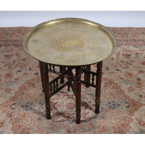 258 - AN ENGRAVED BENARES TRAY on folding stand 56cm (h) x 58cm (d)