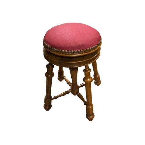 26 - A HARDWOOD AND UPHOLSTERED STOOL with adjustable seat the circular upholstered seat with brass studs... 