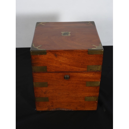 261 - A GEORGIAN MAHOGANY AND BRASS BOUND DECANTER BOX of square form the hinged lid containing four decan... 