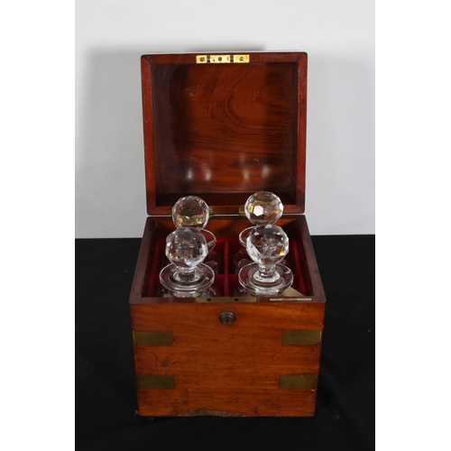 261 - A GEORGIAN MAHOGANY AND BRASS BOUND DECANTER BOX of square form the hinged lid containing four decan... 