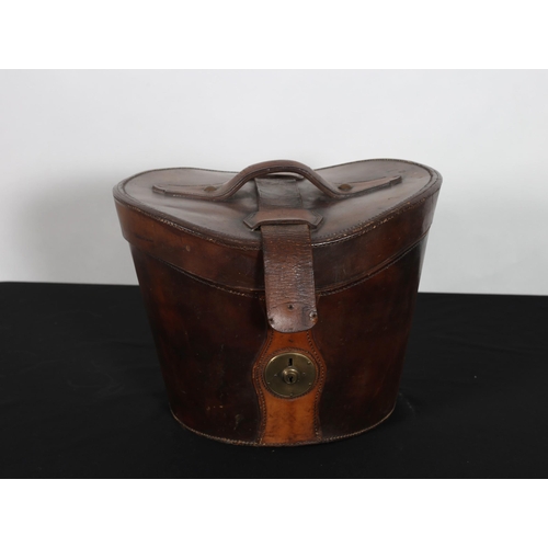 262 - A VICTORIAN LEATHER HAT BOX with brass clasp and carrying handle 27cm (h) x 38cm (w) x 38cm (d)