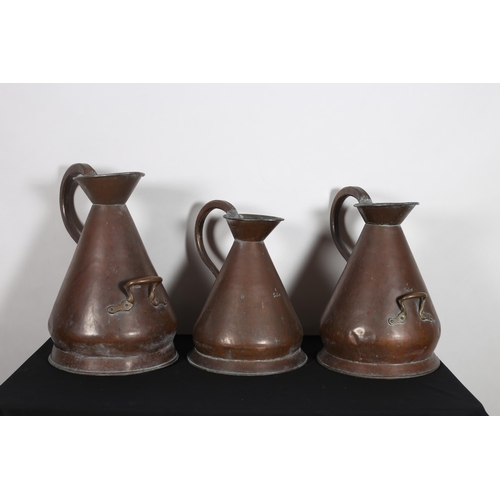 266 - A SET OF THREE 19TH CENTURY COPPER MEASURES of typical form comprising a three gallon measure, a fou... 