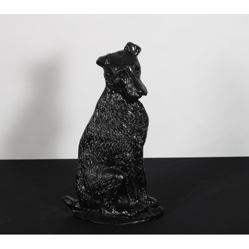 273 - A CAST IRON DOORSTOP modelled as a dog shown seated on a circular foot 38cm (h)