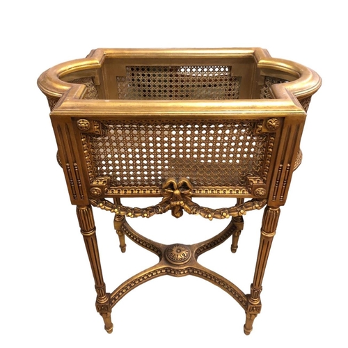 29 - A CONTINENTAL GILTWOOD AND CANED JARDINIERE STAND of rectangular bowed outline the shaped top with c... 