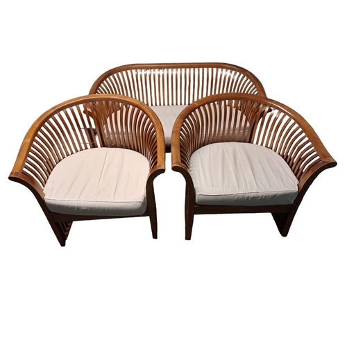 352 - A THREE PIECE HARDWOOD SUITE comprising a two seater settee the shaped top rail with slatted splats ... 