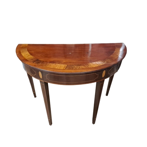 358 - A GEORGIAN DESIGN MAHOGANY CROSSBANDED SIDE TABLE of demi lune outline the shaped top above a moulde... 