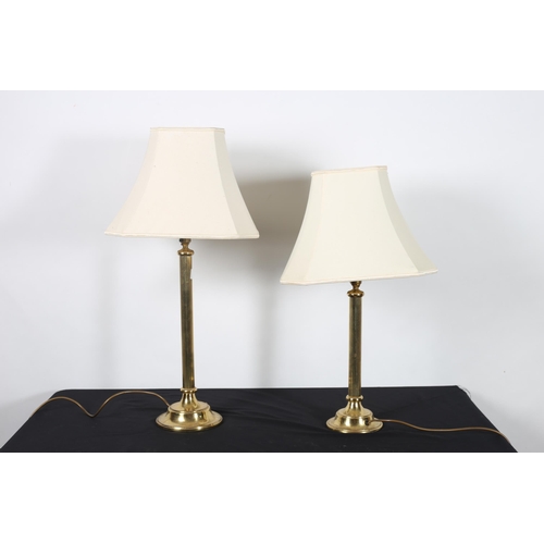 370 - TWO BRASS TABLE LAMPS each with a reeded column on a circular spreading foot with shades The larger ... 