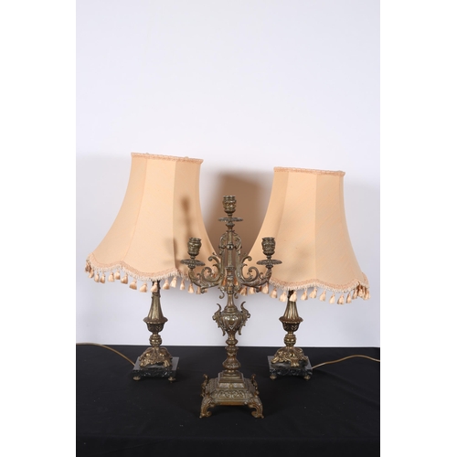 375 - A PAIR OF GILT METAL TABLE LAMPS each with an urn shaped column on triform base with brass base and ... 