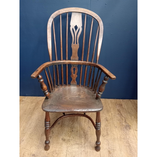 378 - A VINTAGE OAK WINDSOR CHAIR of typical form with pierced vertical splat and shaped seat on baluster ... 