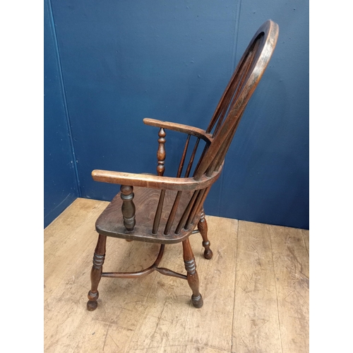 378 - A VINTAGE OAK WINDSOR CHAIR of typical form with pierced vertical splat and shaped seat on baluster ... 