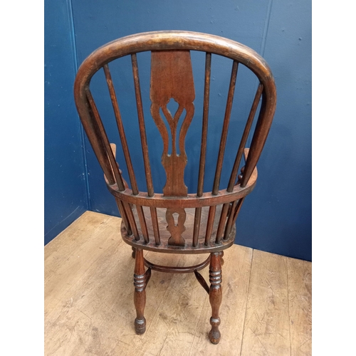 378 - A VINTAGE OAK WINDSOR CHAIR of typical form with pierced vertical splat and shaped seat on baluster ... 