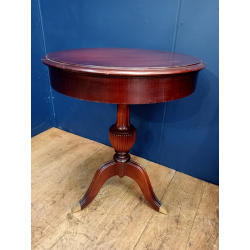 384 - A MAHOGANY OCCASIONAL TABLE of circular outline the shaped top above a fluted urn column on tripod s... 