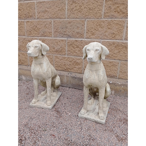 387 - A PAIR OF COMPOSITION STONE FIGURES each modelled as a hound shown seated on a rectangular base 72cm... 