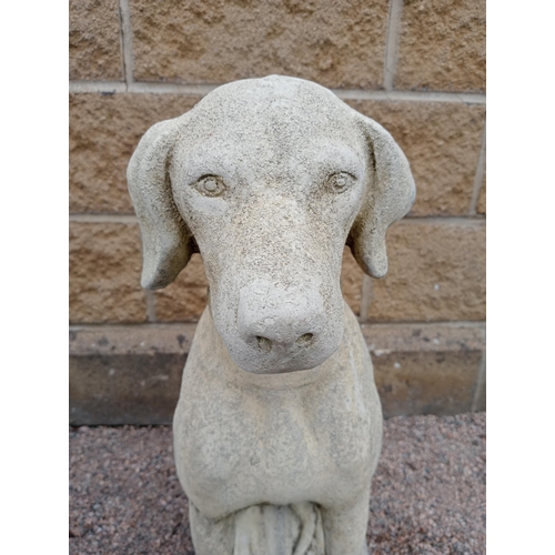 387 - A PAIR OF COMPOSITION STONE FIGURES each modelled as a hound shown seated on a rectangular base 72cm... 