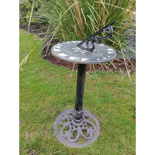 390 - A CAST IRON SUNDIAL the cylindrical dial inscribed above a fluted column on a circular pierced foot ... 