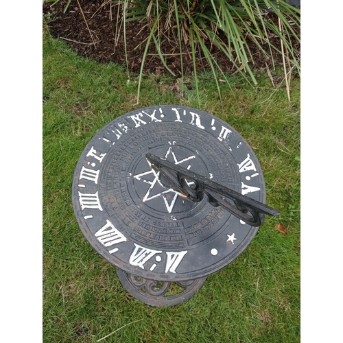 390 - A CAST IRON SUNDIAL the cylindrical dial inscribed above a fluted column on a circular pierced foot ... 