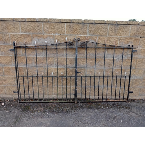 728 - A PAIR OF VINTAGE CAST IRON ENTRANCE GATES with cylindrical barring and sphere head finials with scr... 