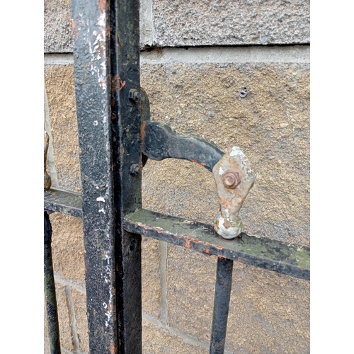 728 - A PAIR OF VINTAGE CAST IRON ENTRANCE GATES with cylindrical barring and sphere head finials with scr... 