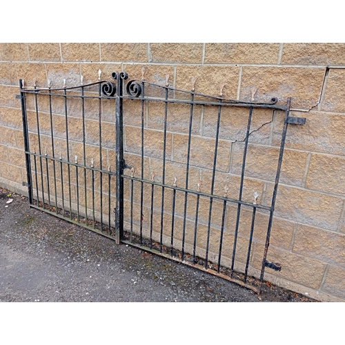 728 - A PAIR OF VINTAGE CAST IRON ENTRANCE GATES with cylindrical barring and sphere head finials with scr... 