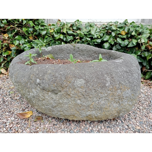 727 - A STONE TROUGH of oval outline 40cm (h) x 80cm (w) x 65cm (d)