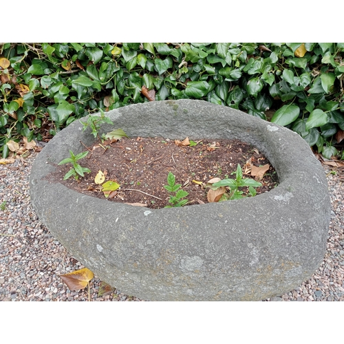 727 - A STONE TROUGH of oval outline 40cm (h) x 80cm (w) x 65cm (d)