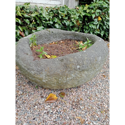 727 - A STONE TROUGH of oval outline 40cm (h) x 80cm (w) x 65cm (d)