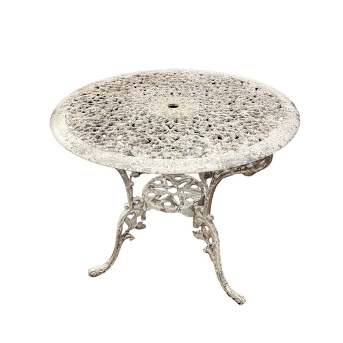 407 - AN ALUMINIUM PATIO TABLE of circular outline the shaped top with pierced foliate decoration on splay... 