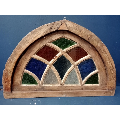 412 - A 19TH CENTURY OAK STAINED GLASS FAN LIGHT WINDOW of demi lune outline 63cm (h) x 94cm (w) x 55cm (d... 