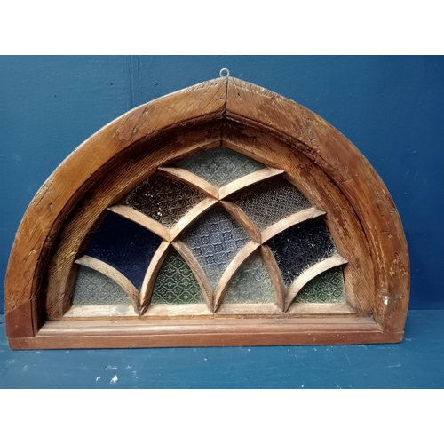 413 - A 19TH CENTURY OAK STAINED GLASS FAN LIGHT WINDOW of demi lune outline 63cm (h) x 94cm (w) x 10cm (d... 