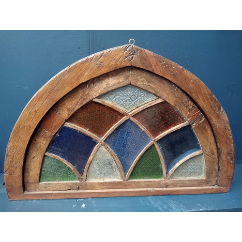 413 - A 19TH CENTURY OAK STAINED GLASS FAN LIGHT WINDOW of demi lune outline 63cm (h) x 94cm (w) x 10cm (d... 