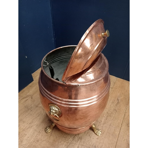 422 - A 19TH CENTURY COPPER CONTAINER of cylindrical form with hinged lid and shovel with brass lion mask ... 