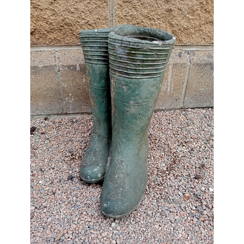 426 - A PAIR OF COMPOSITION STONE PLANTERS modelled as wellington boots 35cm (h) x 38cm (w) x 25cm (d)