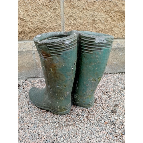 426 - A PAIR OF COMPOSITION STONE PLANTERS modelled as wellington boots 35cm (h) x 38cm (w) x 25cm (d)