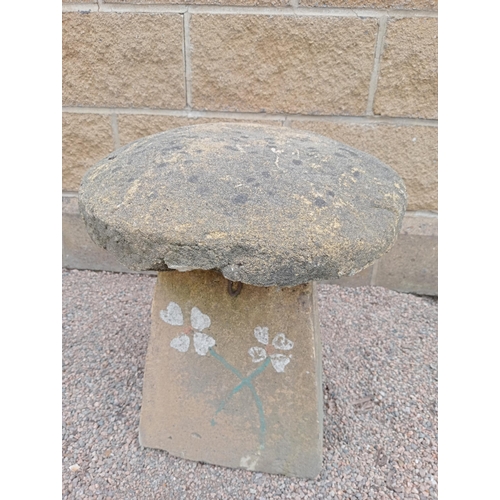 433 - A COMPOSITION SANDSTONE SADDLE STONE the cylindrical top above a spreading column 50cm (h) x 45cm (d... 