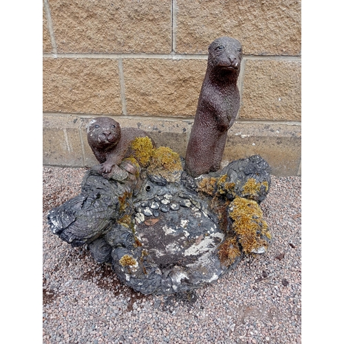 435 - A COMPOSITION STONE WATER FEATURE the rockwork base shown with otters 55cm (h) x 65cm (w) x 52cm (d)