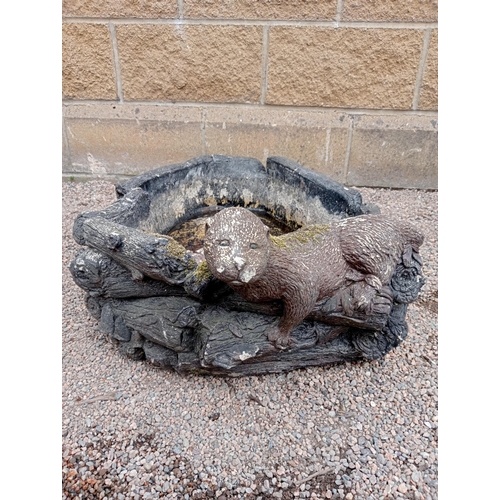 436 - A COMPOSITION STONE RUSTIC WATER FEATURE surmounted by an otter 28cm (h) x 58cm (w) x 79cm (d)