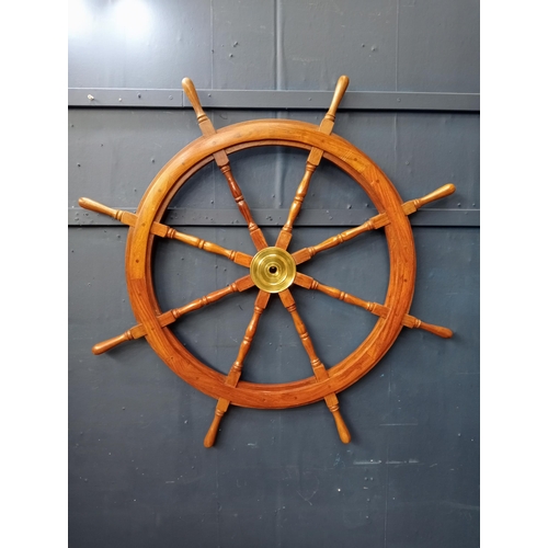 438 - A TEAK AND BRASS SHIP'S WHEEL of typical form with baluster spindles 107cm (d)