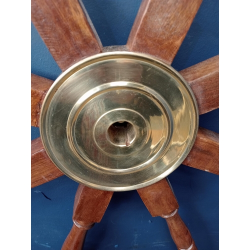 438 - A TEAK AND BRASS SHIP'S WHEEL of typical form with baluster spindles 107cm (d)