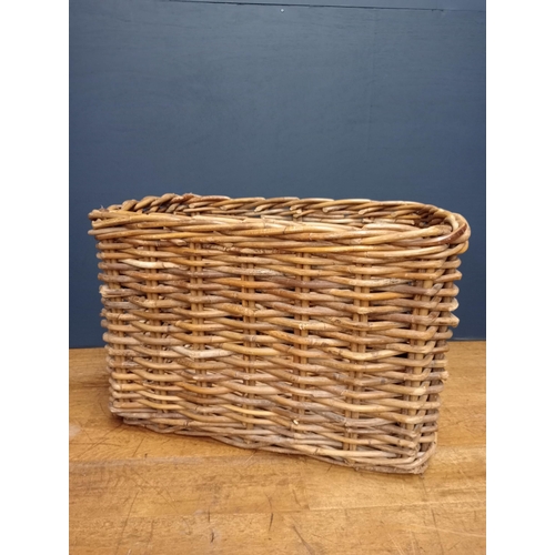 439 - A WICKER LOG BASKET of rectangular form with carrying handles 60cm (h) x 92cm (w) x 62cm (d)