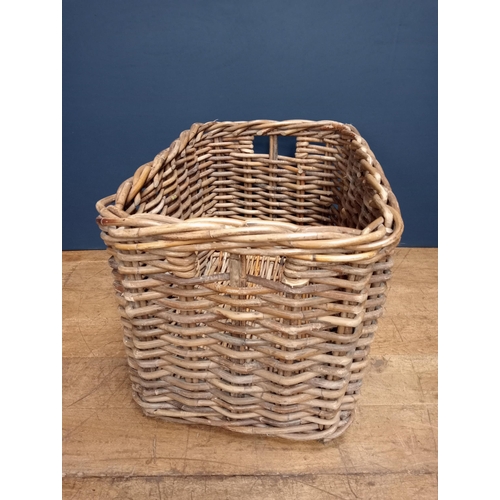 439 - A WICKER LOG BASKET of rectangular form with carrying handles 60cm (h) x 92cm (w) x 62cm (d)