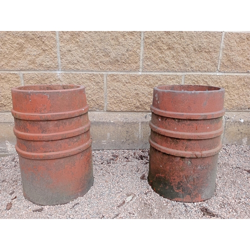 443 - A PAIR OF RED TERRACOTTA CHIMNEY POTS each of cylindrical form with band decoration 45cm (h) x 28cm ... 