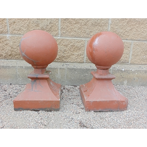 444 - A PAIR OF RED TERRACOTTA CAPPINGS each of cylindrical form raised on a square spreading base 54cm (h... 